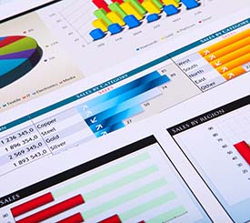 A group of graphs and charts on a table, providing proposal support for the Federal Government.