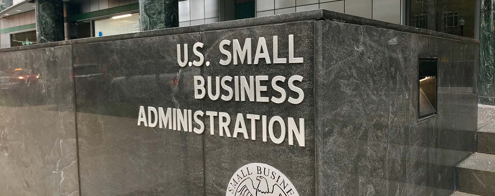 The U.S. Small Business Administration sign is in front of a building offering Proposal Support for businesses seeking assistance from the Federal Government.
