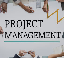 A group of people sitting around a table discussing GSA project management for the Federal Government.