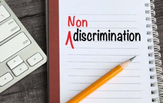 A GSA notebook with the word non discrimination prominently displayed next to a keyboard for Federal Government proposal support. | Revolutionary Solutions A GSA notebook with the word non discrimination prominently displayed next to a keyboard for Federal Government proposal support.