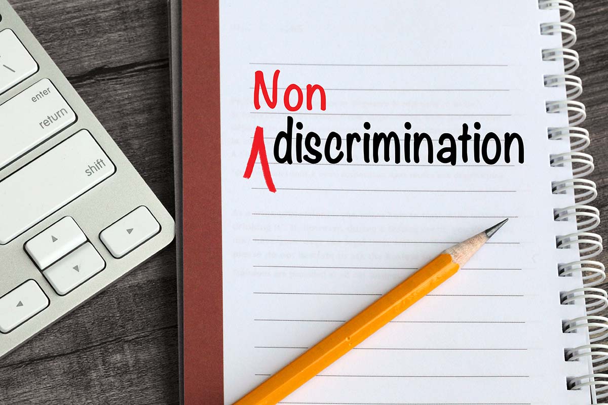 A GSA notebook with the word non discrimination prominently displayed next to a keyboard for Federal Government proposal support.