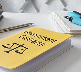A yellow book with the words Federal Government contracts on it.