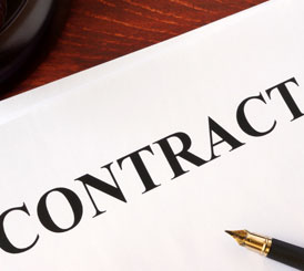 A document with the word contract sitting on top of a wooden table for GSA proposal support.