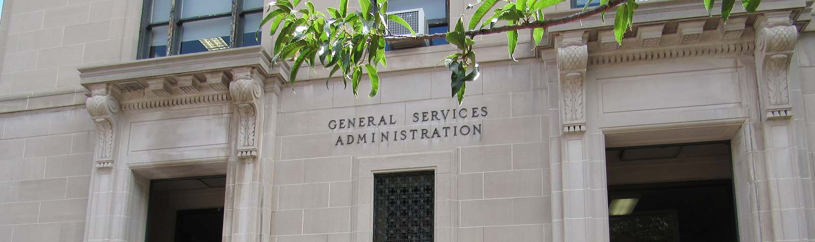 A federal government building with a tree in front of it, providing GSA proposal support.