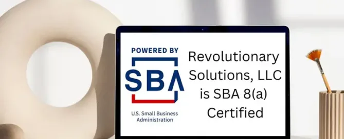 A laptop screen displays the SBA logo with text stating "Revolutionary Solutions, LLC is SBA 8(a) Certified." Decorative objects sit on the desk.